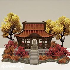 a model of a chinese pavilion with trees and flowers around the gazebo is shown