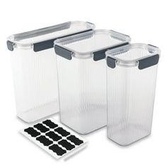 three clear storage containers with black lids