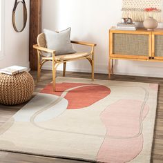 a living room with a chair and rug on the floor