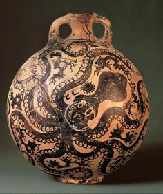 an intricately decorated vase is shown against a black background with white and brown designs