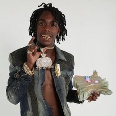 a man with dreadlocks holding money in his hand