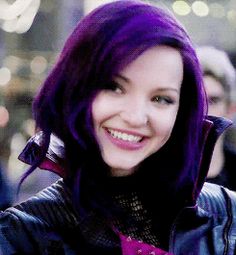 a woman with purple hair is smiling at the camera