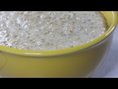 a yellow bowl filled with oatmeal sitting on top of a table