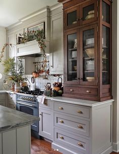 the kitchen is clean and ready to be used for cooking or baking, with an old - fashioned china cabinet in the center