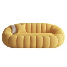 a yellow couch with pillows on it and a pillow sitting on top of the cushion