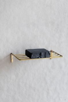 a black object sitting on top of a gold shelf