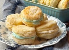 a plate that has some cookies on it and is next to another plate with biscuits