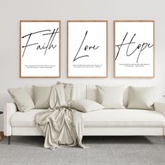 two framed posters with the words faith, love and hope on them in a living room