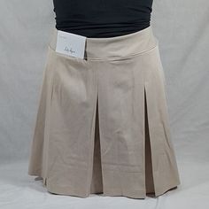 Women's Lady Hagen 16" Pleated Skort Various Sizes Color: Light Khaki Standard Fit Golf Skort 16" Length Regular Risesits Below The Natural Waist Breathable Fabric Helps You To Stay Cool All Day Pleated Skort Design For Classic Detail On The Course Built-In Under-Short Provides Additional Coverage As You Move Moisture-Wicking Fabric Moves Sweat Away From The Skin To Keep You Dry And Comfortable Wrinkle-Resistant For A Fresh, Clean Look Fabric: Body: 92% Polyester 8% Spandex Under-Short: 80% Poly Beige Pleated Short Length Bottoms, Beige Pleated Short Bottoms, Casual Cotton Tennis Skirt With Short Inseam, Casual Knee-length Tennis Skirt For Summer, Casual Stretch Beige Skort, Casual Knee-length Summer Tennis Skirt, Casual Fitted Beige Skort, Fitted Cotton Pleated Shorts, Fitted Pleated Cotton Shorts