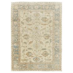 a beige and blue rug with an ornate design on the bottom, in front of a white background