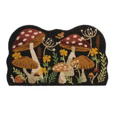 a rug with mushrooms and flowers on it