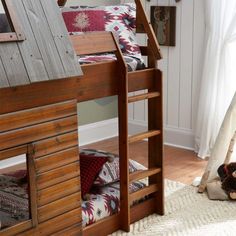 a wooden bunk bed sitting on top of a white rug