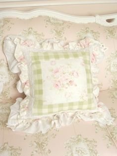 a bed with pink and green flowers on it's headboard is shown in this image