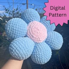 a crocheted blue and pink flower with the words digital pattern written below it