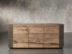 a large wooden cabinet sitting on top of a cement floor next to a concrete wall