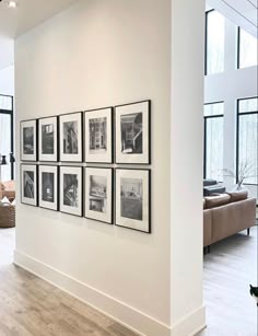 a living room filled with furniture and pictures on the wall