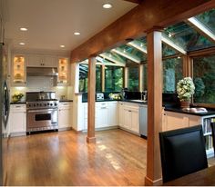 an open kitchen and dining room with wood flooring