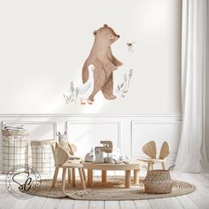 there is a bear and bird wall decal in the room