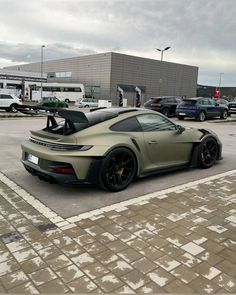 a grey sports car parked in a parking lot