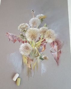 a vase filled with lots of white flowers next to a small pill bottle on top of a table