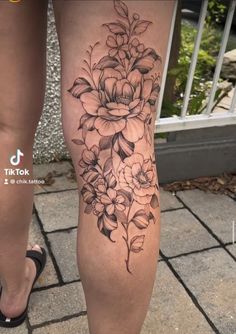 a woman's leg with flowers on it