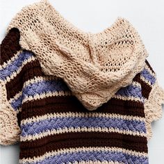 the sweater is knitted and has stripes on it