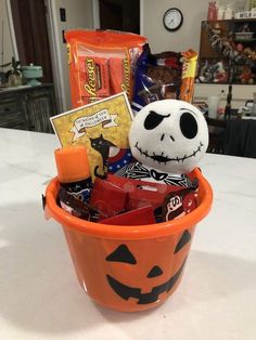 a halloween bucket filled with candy and treats