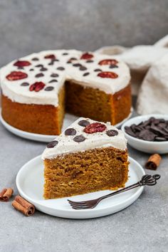 a slice of carrot cake with white frosting on a plate next to two bowls of chocolate chips