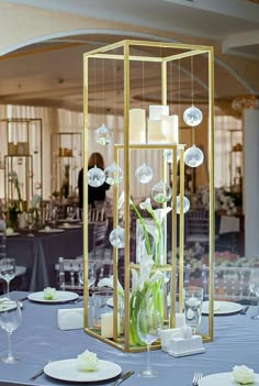 an elegant centerpiece with candles and flowers on a table