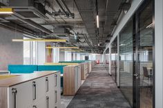 an office with glass walls and wooden desks