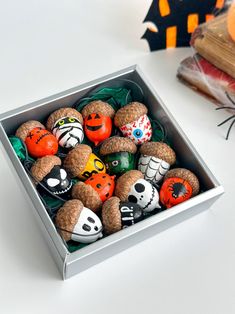 a box filled with halloween decorations on top of a white table next to other items