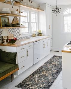 the kitchen is clean and ready to be used for cooking or eating, with white cabinets and open shelving