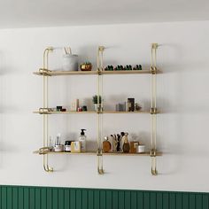 three shelves with various items on them against a white wall in a green and white room