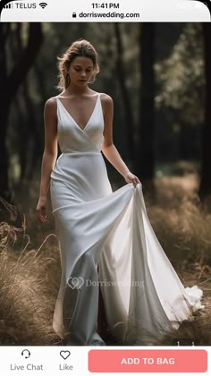 a woman in a white dress is walking through the woods