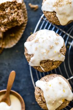 carrot muffins with white icing on a cooling rack