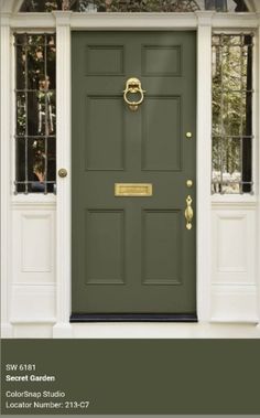 the front door is painted green with gold accents