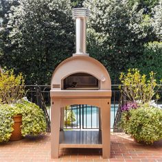 an outdoor pizza oven sitting on top of a brick patio