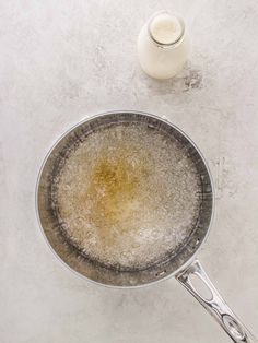 a frying pan filled with food next to a bottle of milk