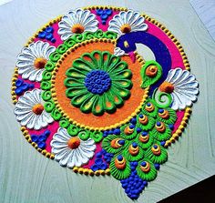 an intricately painted peacock design on a wooden surface