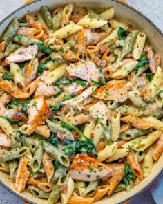 pasta with chicken and spinach in a skillet