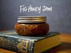 a jar sitting on top of a book with the words fig honey jam written above it