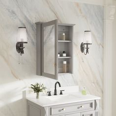 a bathroom with marble walls and flooring, two lights on the wall above the sink