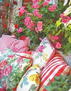 many pillows and flowers are sitting on the ground