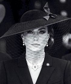 a woman wearing a hat with a veil on it