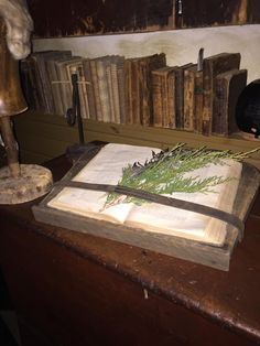 an old book with a knife on top of it