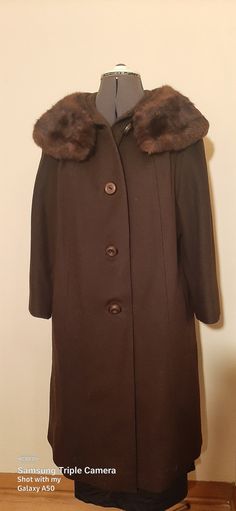 This is a gorgeous wool coat with a faux fur collar and a little swing to the body of the coat, this coat is union-made, but it does not have a maker's name on it.  This coat and lining are in excellent condition. There are four large decorative buttons on the front.  This coat is 18 inches from shoulder to shoulder, 18 inches from underarm to underarm, 20 inches from the shoulder to the end of the sleeve, and from neck to hemline is 35 inches.  Fits size 12 to 14. I do not accept returns, but w Classic Brown Wool Coat With Double-breasted Button, Brown Double-breasted Wool Coat With Double Button, Brown Single-breasted Wool Coat, Brown Long-sleeve Wool Coat, Luxury Brown Double-breasted Wool Coat, Pink Prom Dress, Union Made, Decorative Buttons, Black Leather Handbags