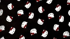 black and white hello kitty print fabric with red bows on the front, dark background