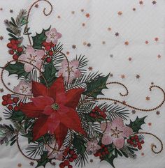 a white table cloth with poinsettis, holly and stars in the background