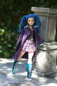 a doll with blue hair is leaning against a stone pillar and posing for the camera