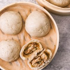 three different types of food in wooden bowls on a marble counter top with one being cut open and the other is half eaten